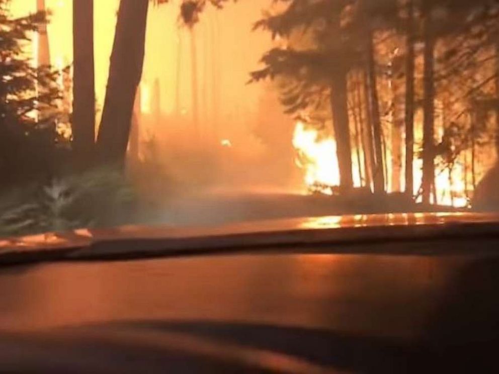 A son and his 70-year-old father barely escaped as they drove right through a raging forest fire in West Glacier, Montana.