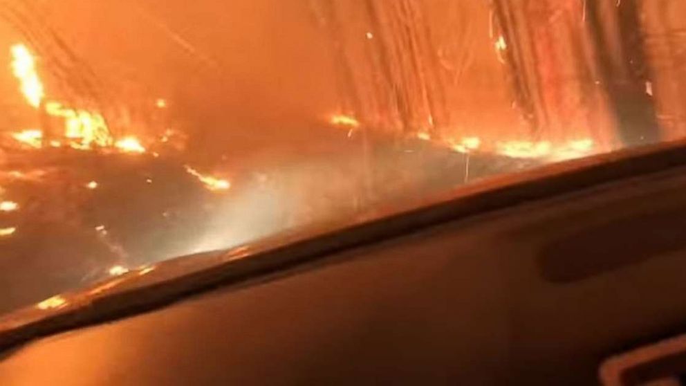 A son and his 70-year-old father barely escaped as they drove right through a raging forest fire in West Glacier, Montana.