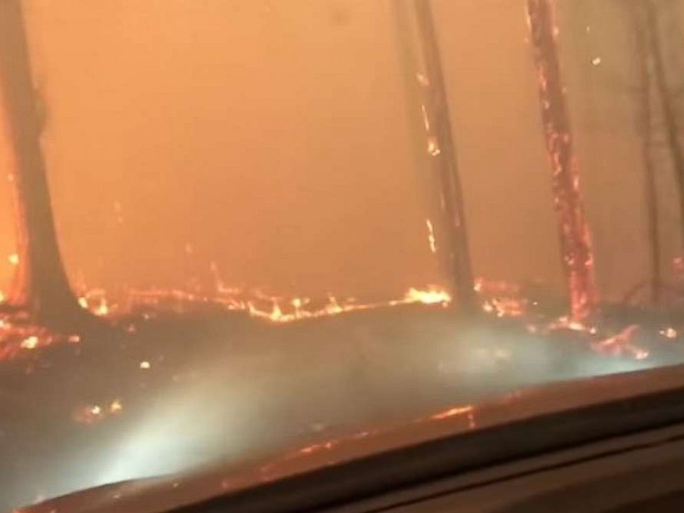 A son and his 70-year-old father barely escaped as they drove right through a raging forest fire in West Glacier, Montana.