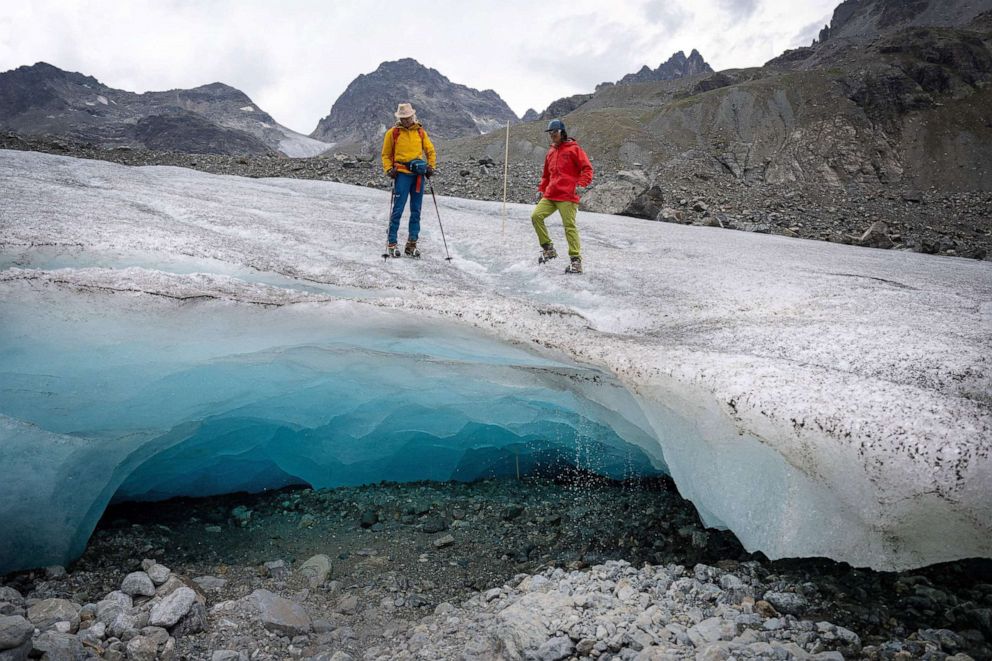 PHOTO: Glaciologists Andrea Fischer (L) and Violeta Lauria from the Austrian Academy of Sciences walk on the Jamtal Glacier (Jamtalferner) near Galtuer, Tyrol, Austria on July 20, 2022. 
