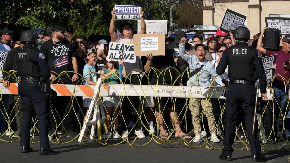 PHOTO: Glendale Police officers keep protesters rallying against exposing children to LGBTQ+ issues in schools separate from supporters outside the Glendale Unified School District headquarters in Glendale, Calif., June 20, 2023.