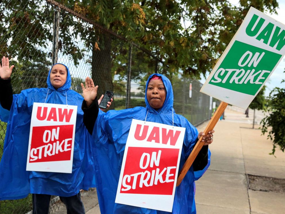 PHOTO: United Auto Workers, Aramark workers, carry strike signs outside the General Motors Detroit-Hamtramck assembly plant in Detroit, Sept. 15, 2019.