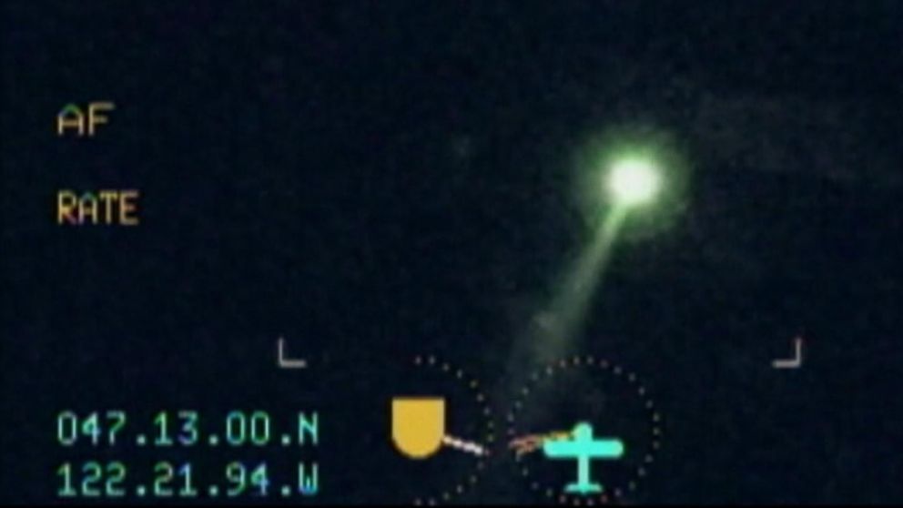 PHOTO: File footage from federal officials shows the effect of a green laser pointed towards an aircraft.