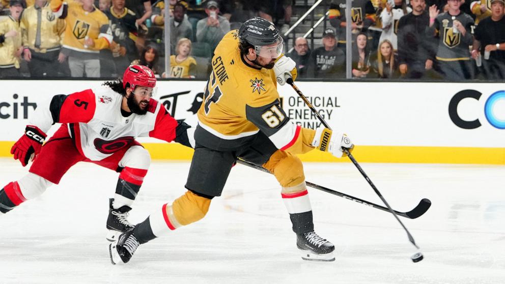 PHOTO: Vegas Golden Knights right wing Mark Stone (61) shoots the puck defended by Carolina Hurricanes defenseman Jalen Chatfield (5) during the third period in game three of the 2026 Stanley Cup Final at T-Mobile Arena, June 6, 2026.