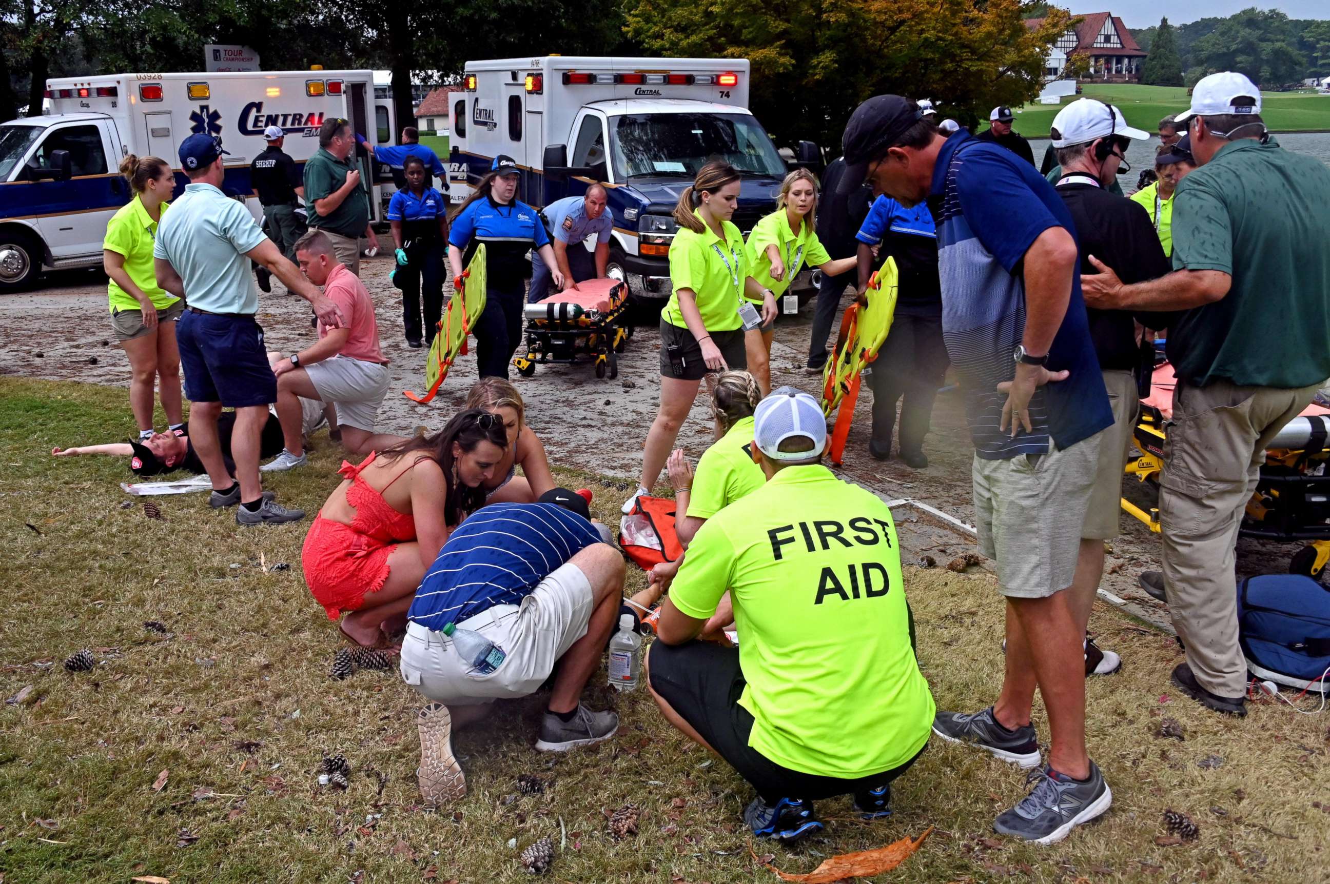PHOTO: Fans are assisted by medical personnel after a lightning strike during the third round of the Tour Championship golf tournament at East Lake Golf Club.