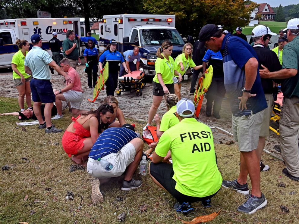 PHOTO: The medical staff assists fans after lightning in the third round of the Tour Championship golf tournament at East Lake Golf Club.