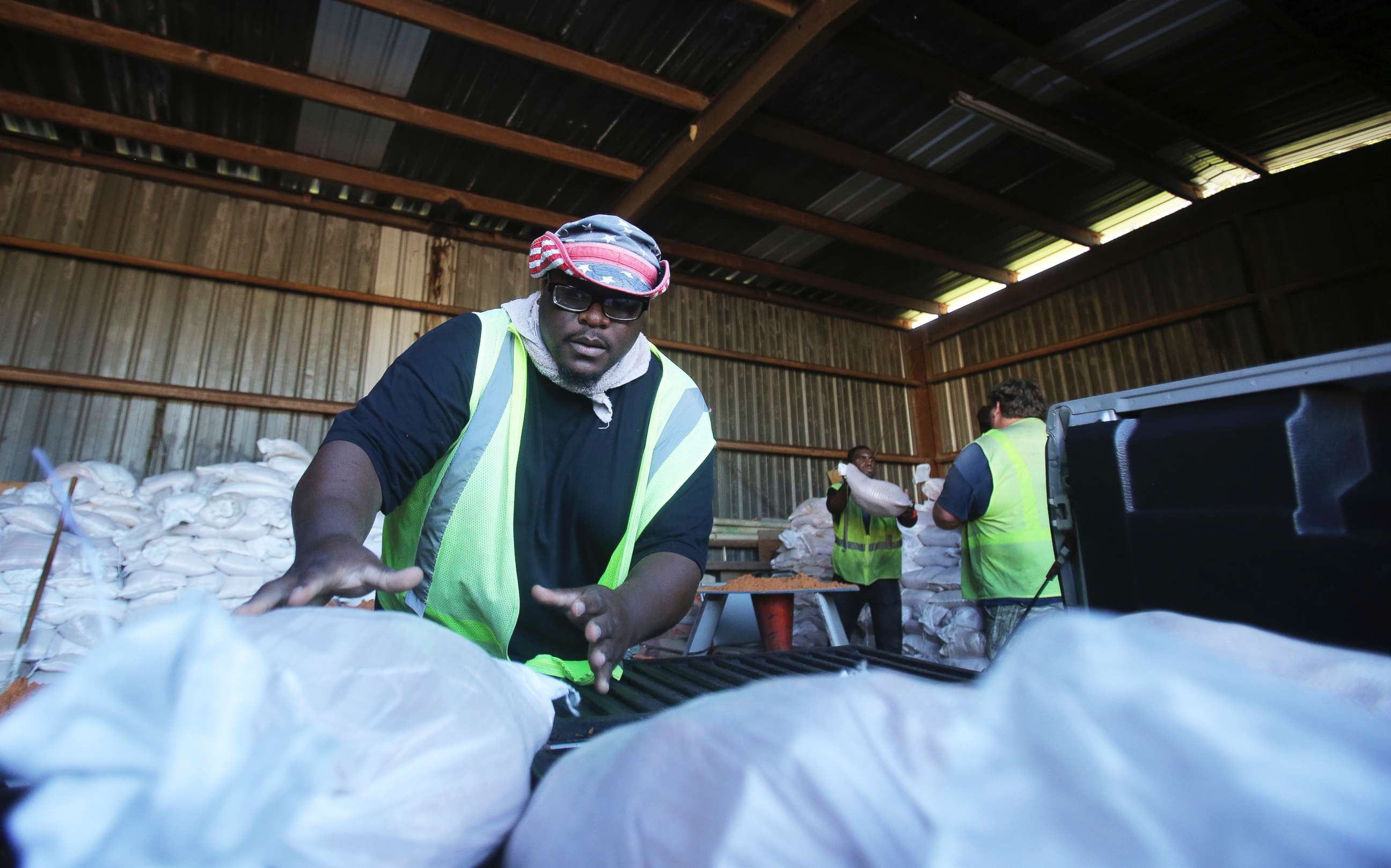 PHOTO: Marquis Chaney, with the City of Saraland, loads a truck up with sand bags to help residents prepare for Tropical Storm Gordon, Sept. 4, 2018, in Saralad, Ala. 