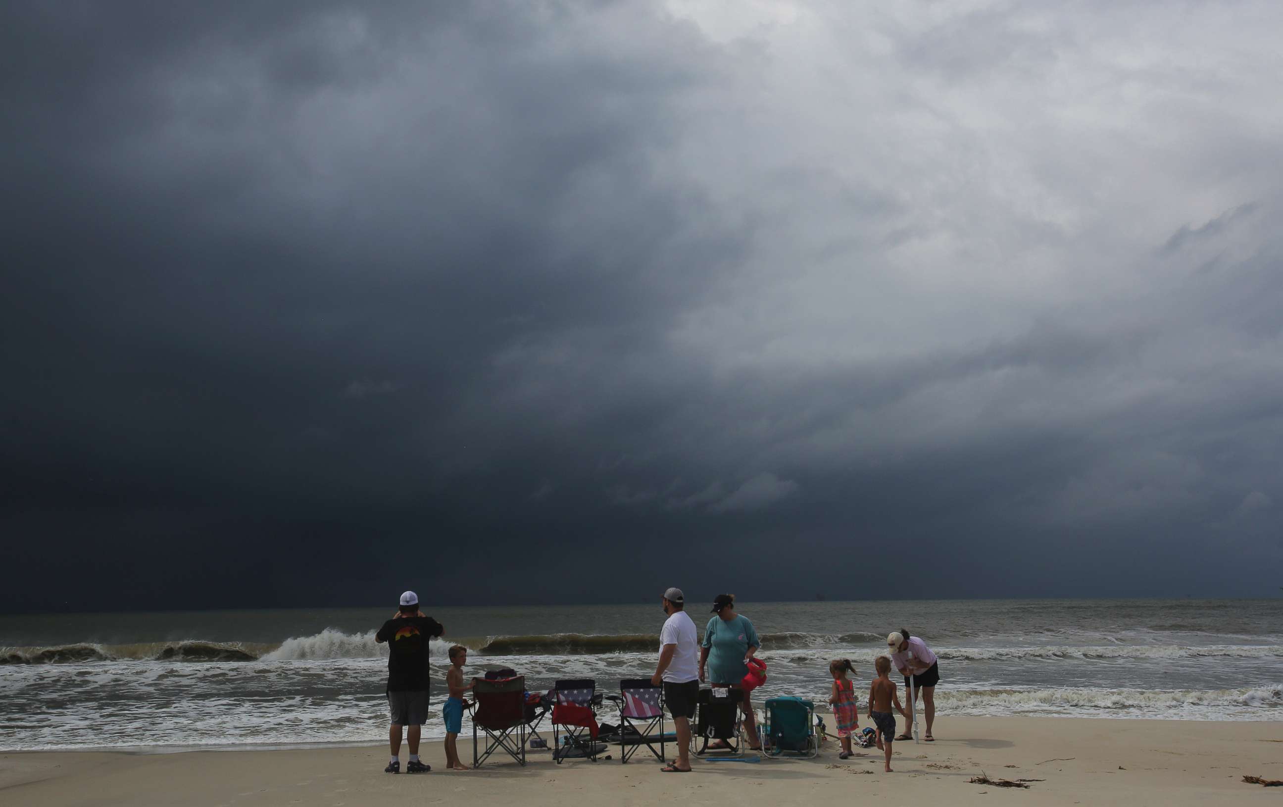PHOTO: A family watches the first rains clouds from Tropical Storm Gordon roll in, Sept. 4, 2018, in Dauphin Island, Ala. 