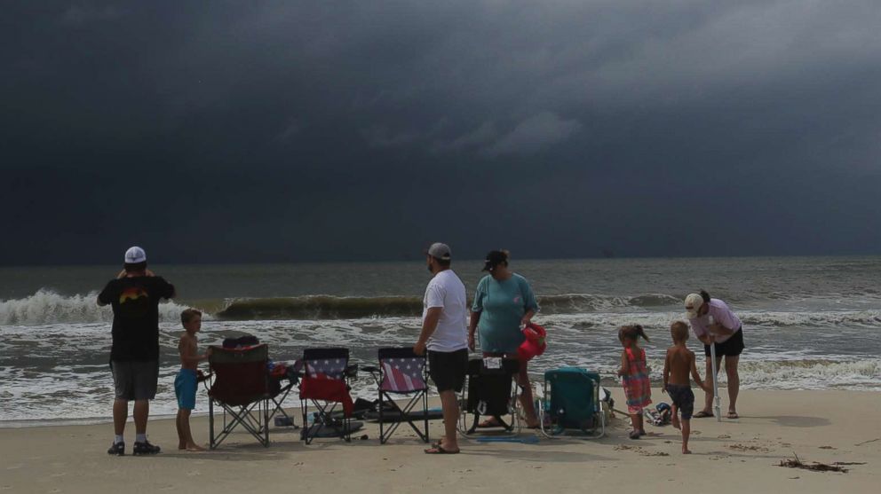 PHOTO: A family watches the first rains clouds from Tropical Storm Gordon roll in, Sept. 4, 2018, in Dauphin Island, Ala. 