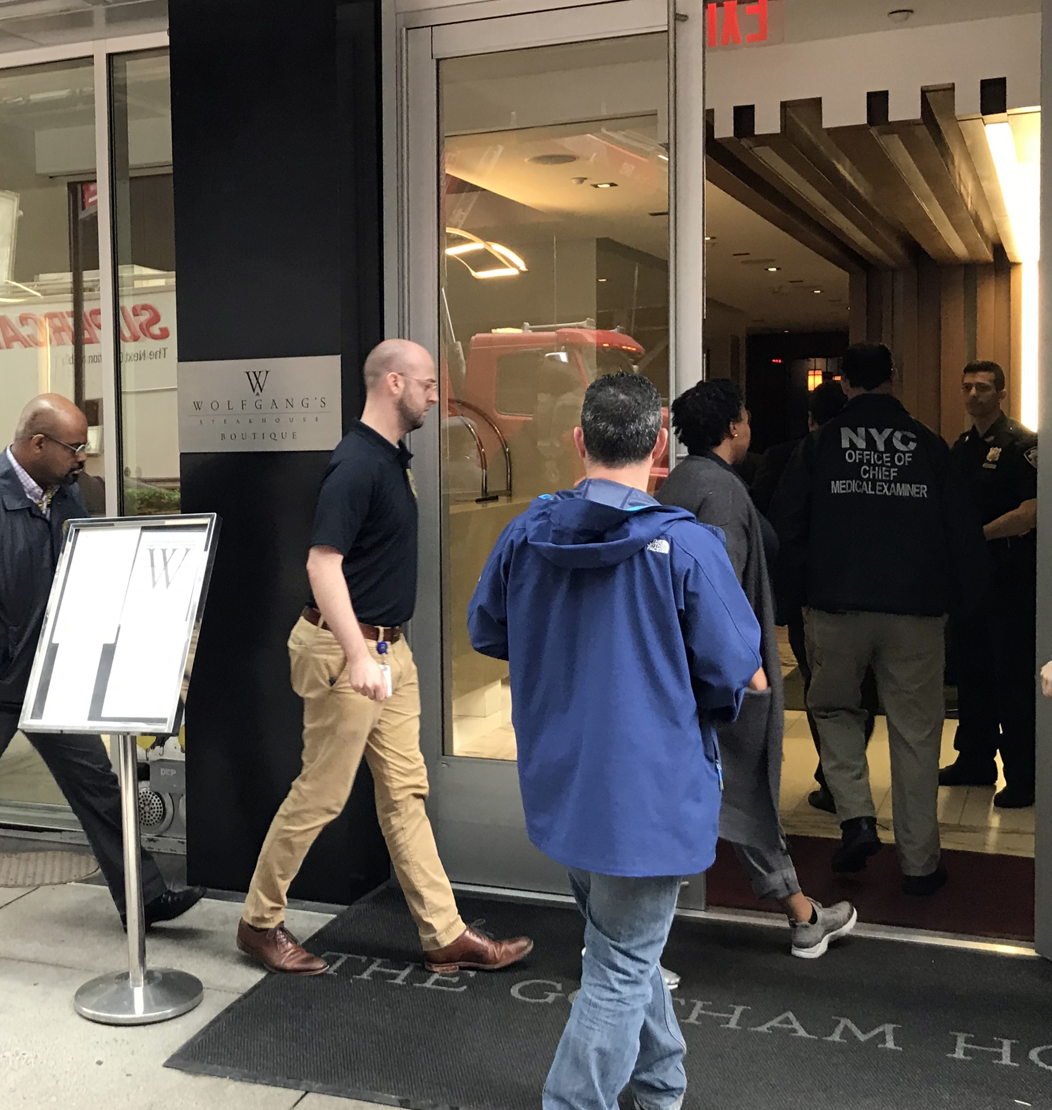 PHOTO: Authorities from the New York City Office of the Chief Medical Examiner enter the Gotham Hotel in New York after reports that a woman jumped from the building with a child on May 18, 2018.