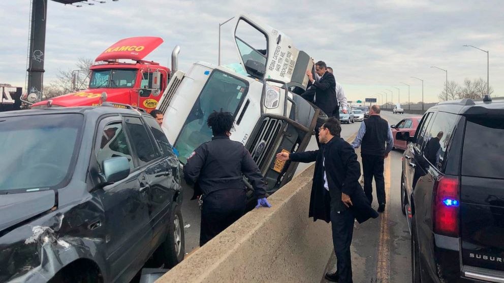 PHOTO: New York Governor Andrew Cuomo stands on a concrete wall and holds open the door to an overturned van on the Brooklyn Queens Expressway, Jan. 6, 2020 in New York.