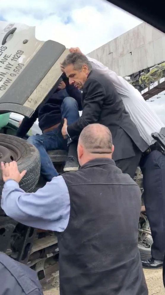 PHOTO: New York Governor Andrew Cuomo helps a man out of a vehicle turned on its side on the Brooklyn-Queens Expressway (BQE) in New York, Jan. 6, 2020, in this still image obtained from video.