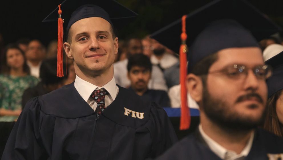 PHOTO: Aldo Amenta used an exoskeleton to walk across the stage to get his diploma at Florida International University. 