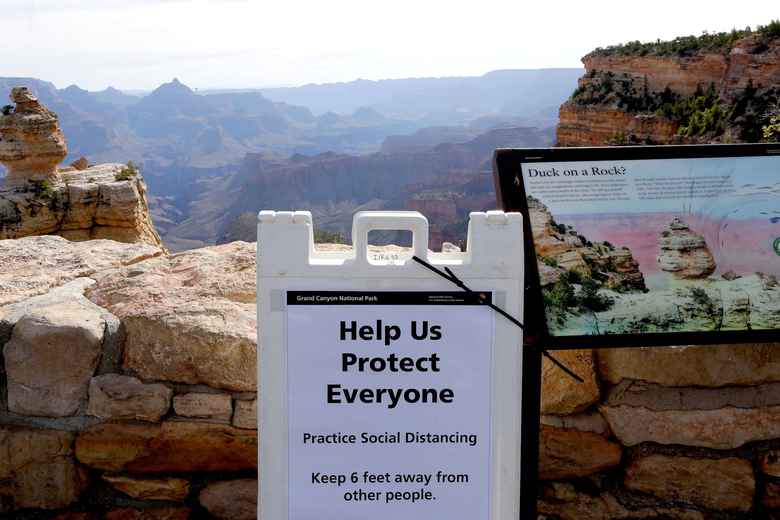 PHOTO: A social distancing sign is seen at the Grand Canyon Friday, May 15, 2020, in Grand Canyon, Ariz.
