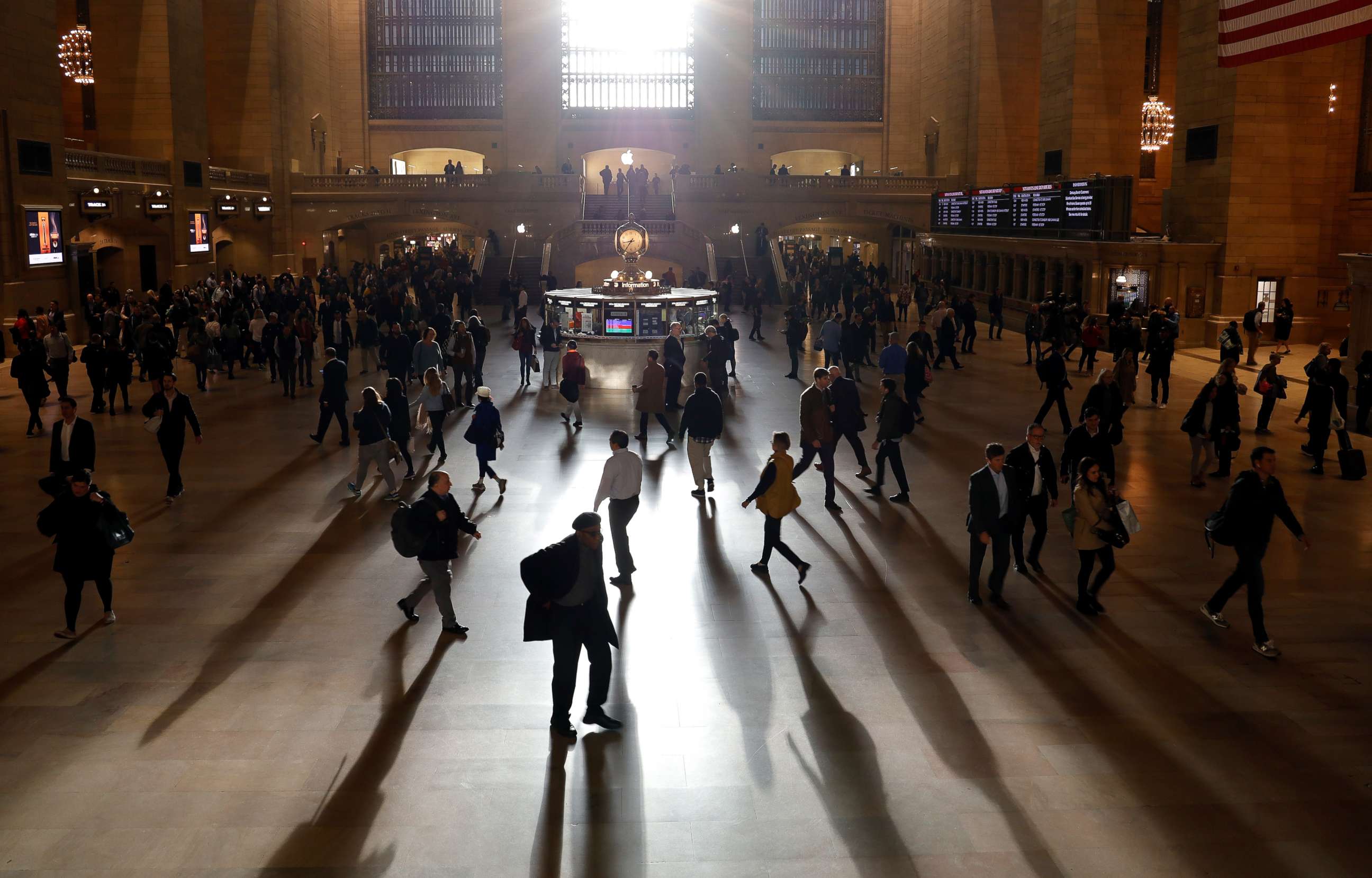 PHOTO: Commuters make their way through Grand Central Terminal as the sun rises through the east facade on Oct. 28, 2019, in New York.