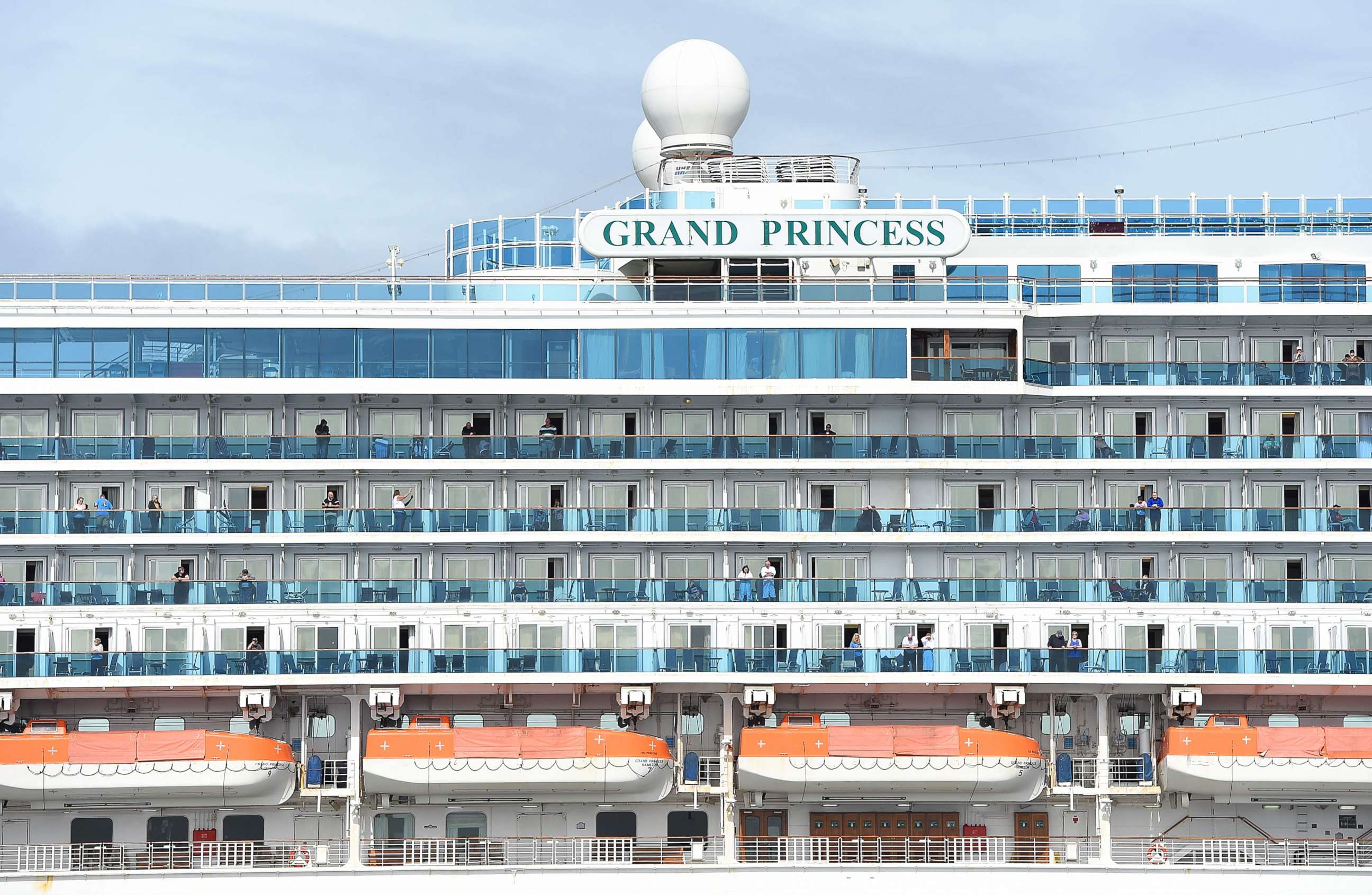 PHOTO: Passengers look out from aboard the Grand Princess cruise ship, operated by Princess Cruises, as it maintains a holding pattern about 25 miles off the coast of San Francisco, Calif., on March 8, 2020. 