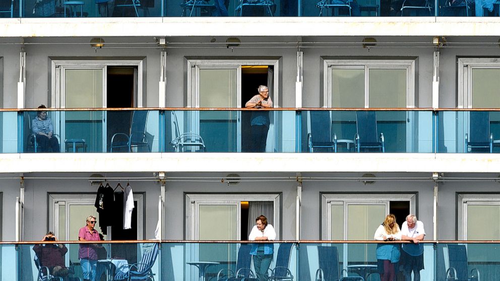 PHOTO: Passengers look out from balconies aboard the Grand Princess cruise ship as it maintains a holding pattern about 25 miles off the coast of San Francisco, California, on March 8, 2020.