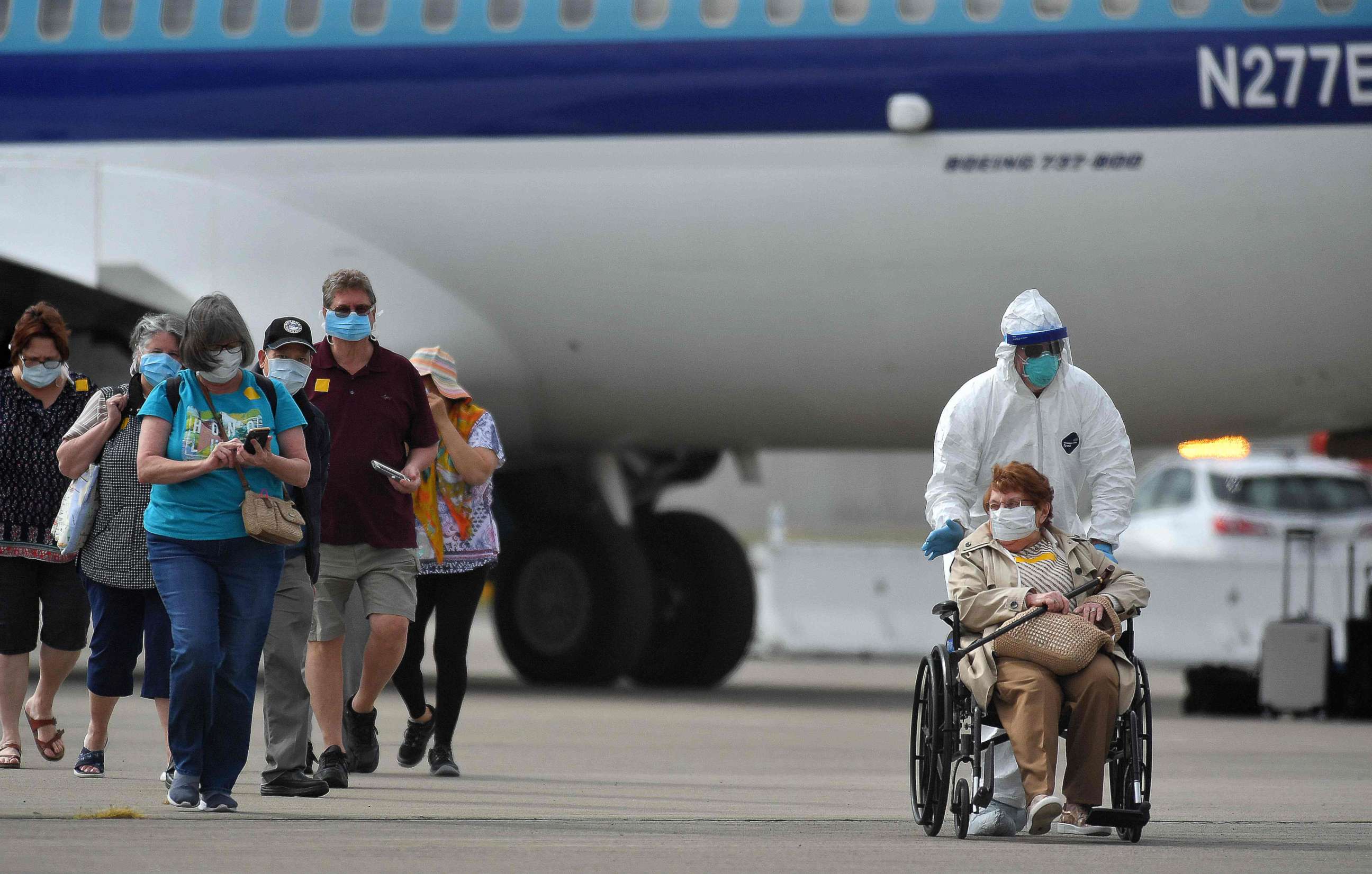 PHOTO: Medical personnel help load passengers from the Grand Princess cruise ship onto airplanes at Oakland International Airport in Oakland, California, on March 10, 2020. 