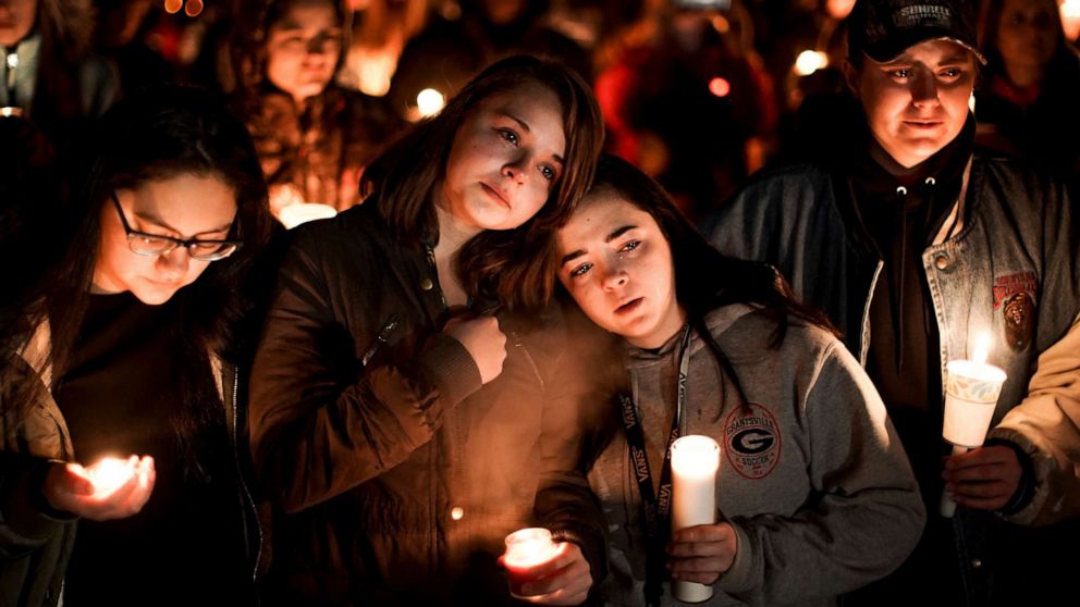 PHOTO: High School girls stand together at a candlelight vigil for the Haynie family at City Park in Grantsville, Utah, Jan. 20, 2020.