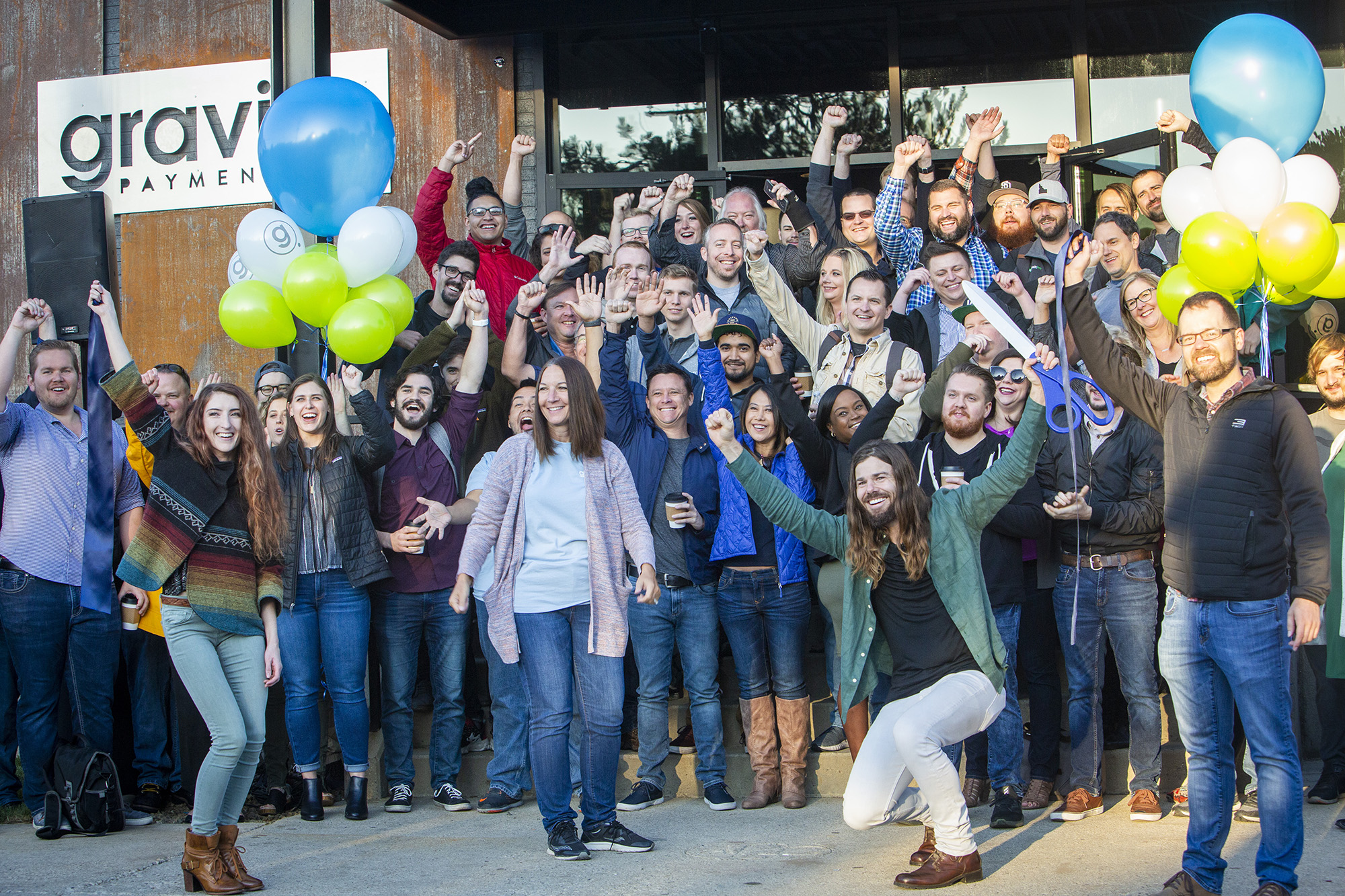 PHOTO: Dan Price, in the green shirt, CEO of Gravity Payments, celebrates the opening of Gravity Payments' new Boise office. Price said he expects to add more workers over time. (Katherine Jones/Idaho Statesman/Tribune News Service via Getty Images)