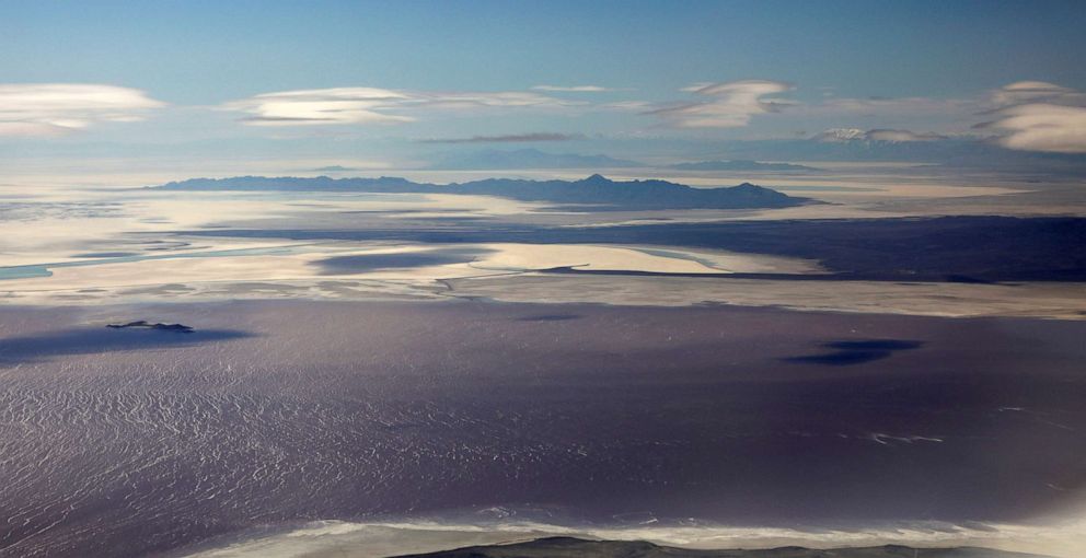 PHOTO: In this April 14, 2020 file photo The salt covered lake bed and saline waters of the Great Salt Lake are pictured from north of Salt Lake City.