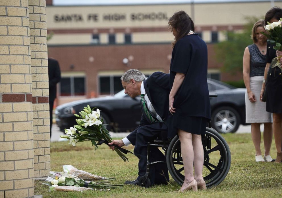 PHOTO: Texas Governor Greg Abbott lays flowers at a makeshift memorial on the grounds of Santa Fe High School, May, 20, 2018, in Santa Fe, Texas.