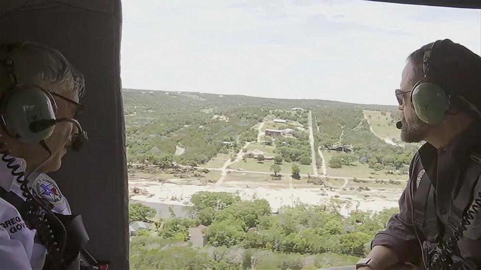 PHOTO: Texas Gov. Greg Abbott rides in a helicopter as he does a flyover above the Kerrville flood damage, July 8, 2025.