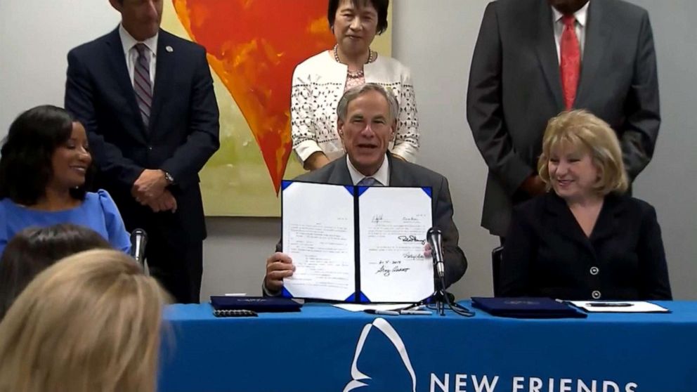 PHOTO: Texas Governor Greg Abbott signs a fertility fraud bill into law during a press conference, June 5, 2019.