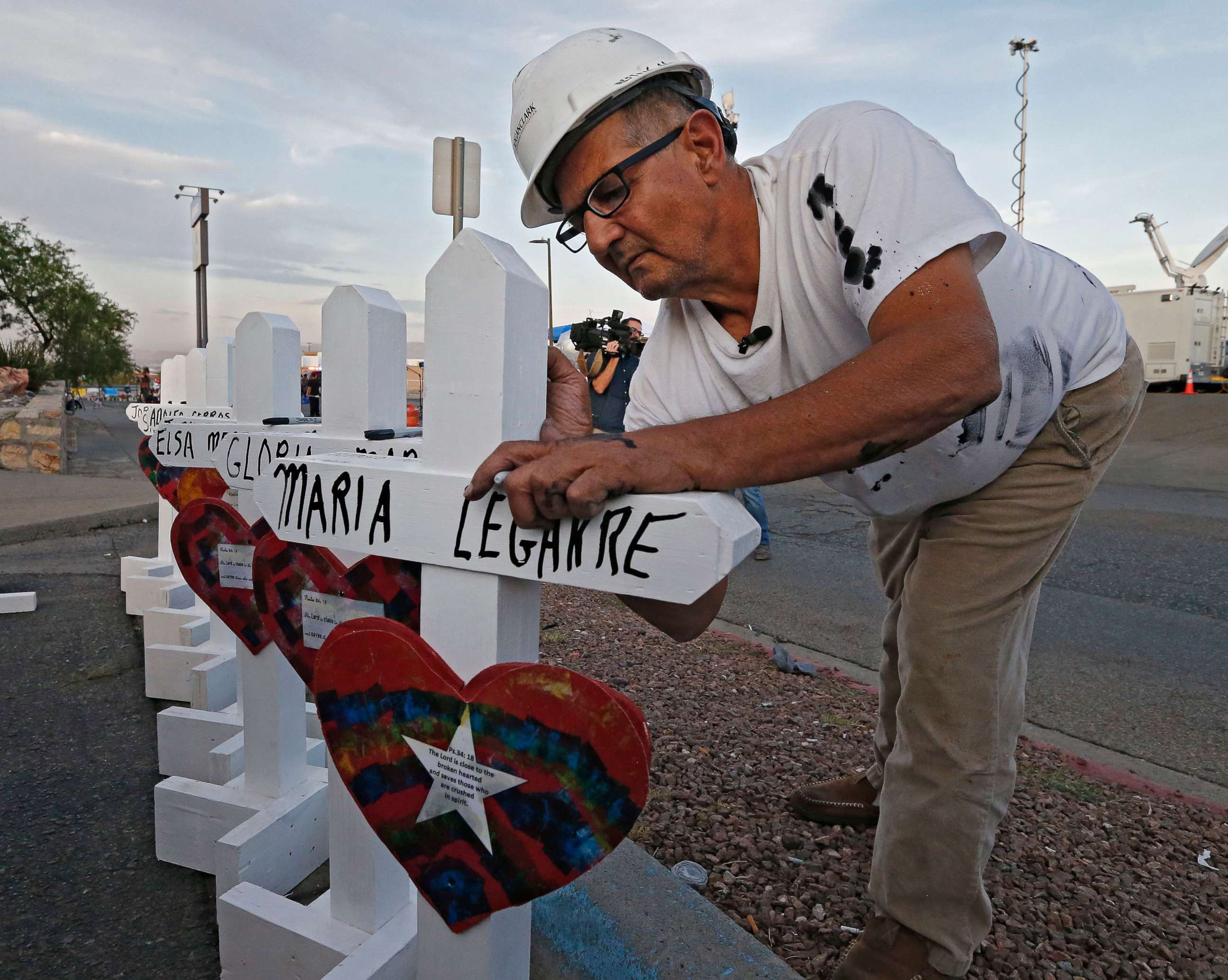 PHOTO: Greg Zanis with Crosses for Losses signs a cross at a makeshift memorial for the victims of a mass shooting that happened at a Walmart in El Paso, Texas, Aug. 5, 2019.