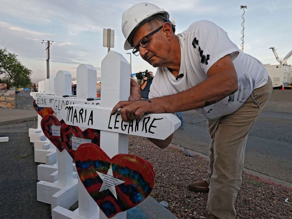 PHOTO: Greg Zanis with Crosses for Losses signs a cross at a makeshift memorial for the victims of a mass shooting that happened at a Walmart in El Paso, Texas, Aug. 5, 2019.