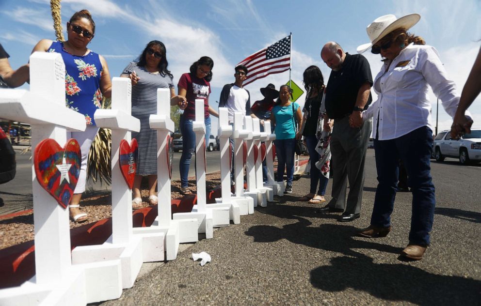 PHOTO: Volunteers pray over white handmade crosses memorializing the victims of a mass shooting which left at least 22 people dead on Aug. 5, 2019 in El Paso, Texas.
