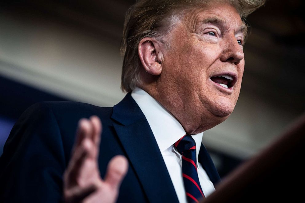 PHOTO: President Donald Trump speaks with members of the coronavirus task force at the White House on March 27, 2020, in Washington.