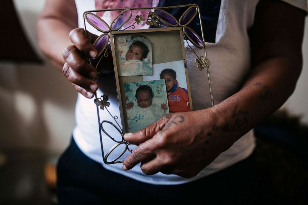 PHOTO: Valerie Griffin holds a frame with a baby photo of her daughter, De'Janay Stanton (top left), at her home in Chicago, Nov. 19, 2021.