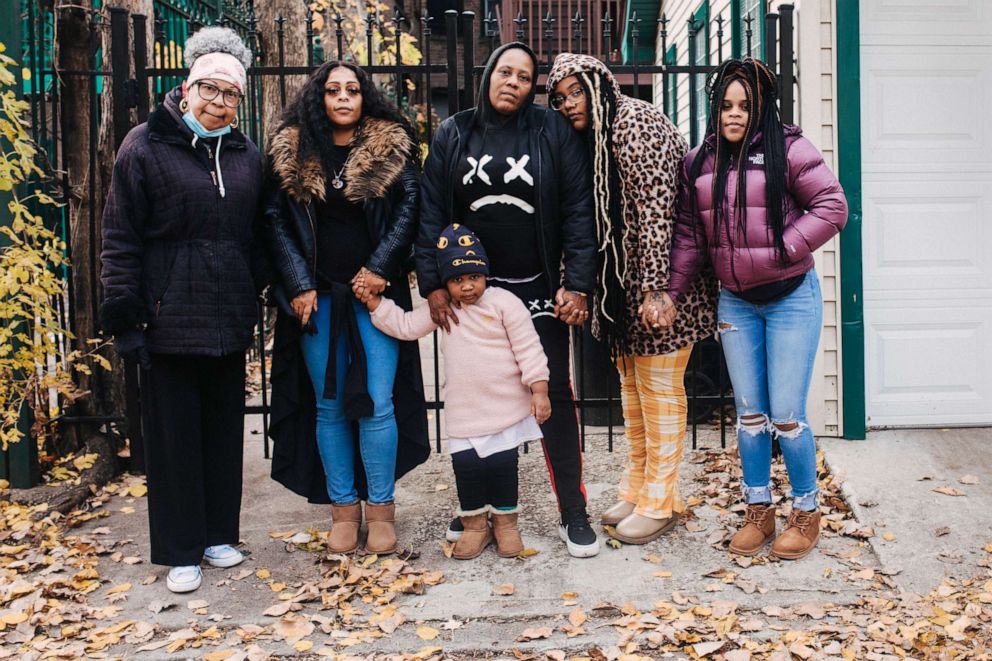 PHOTO: Valerie Griffin, center, stands with family members at the location where her daughter, De'Janay Stanton's body was found in 2018, an alley near the 4000 block of Martin Luther King Drive in Chicago, Nov. 19, 2021.