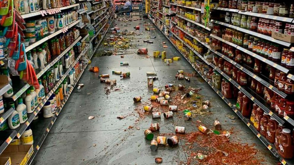 PHOTO: Food that fell from the shelves litters the floor of an aisle at a Walmart following an earthquake in Yucca Yalley, Calif., on Friday, July 5, 2019.