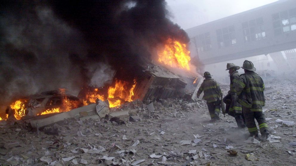 Firefighters look for survivors as they walk through the rubble of the collapsed World Trade Center in New York, Sept. 11, 2001.