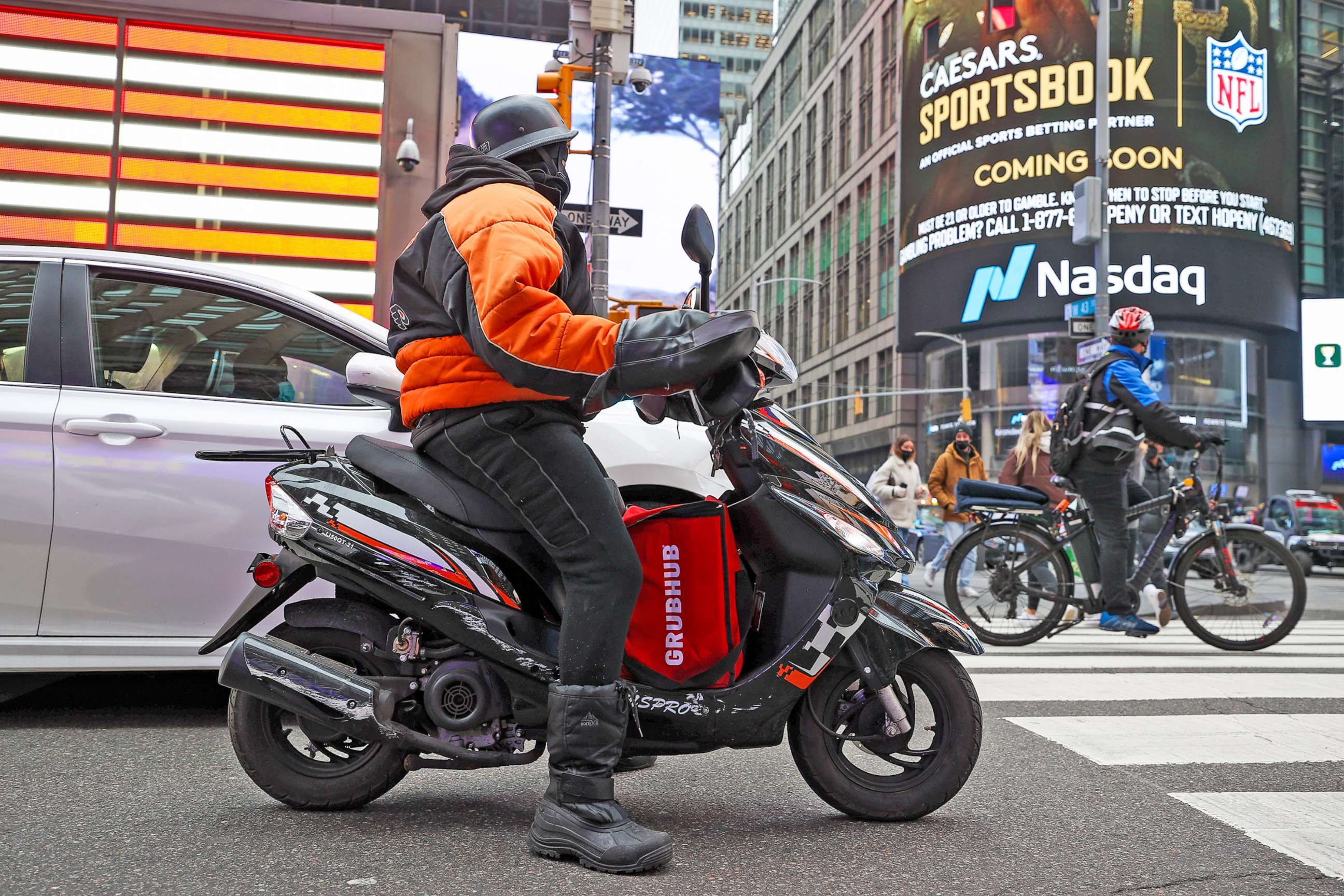 PHOTO: A Grubhub food delivery person rides a scooter near Times Square in New York City,  Dec. 29, 2021.