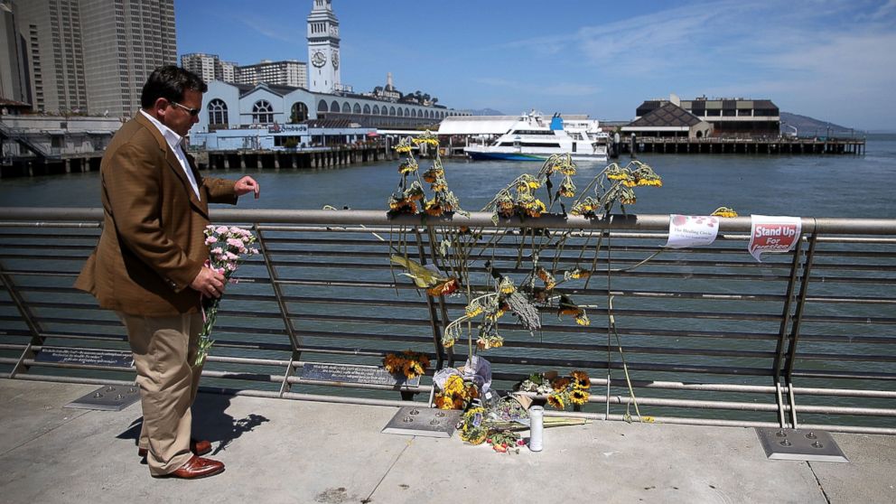 A well-wisher drops off flowers at the site where 32-year-old Kathryn Steinle was killed on July 6, 2015 in San Francisco.