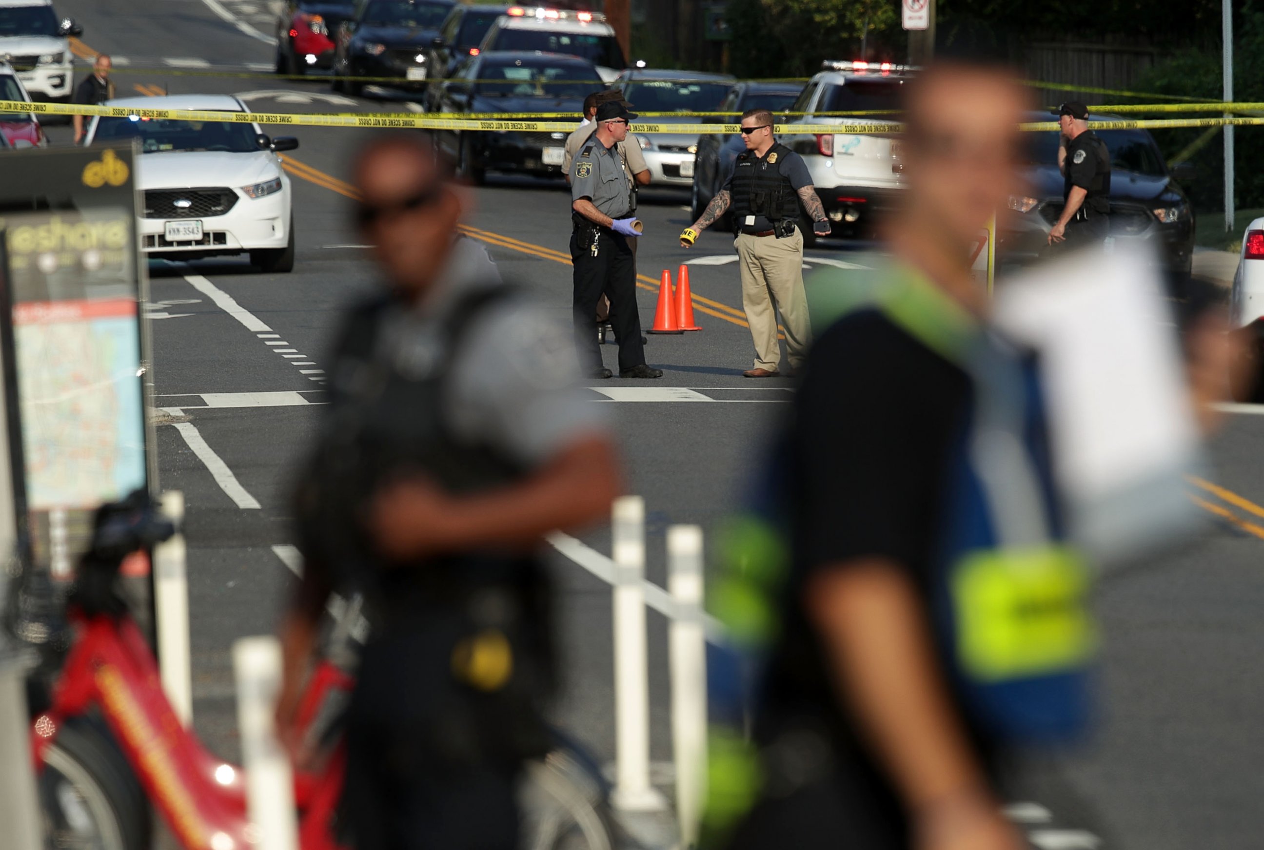 PHOTO: Investigators gather near the scene where fires were shot near where congressmen were gathered, June 14, 2017 in Alexandria, Va. 