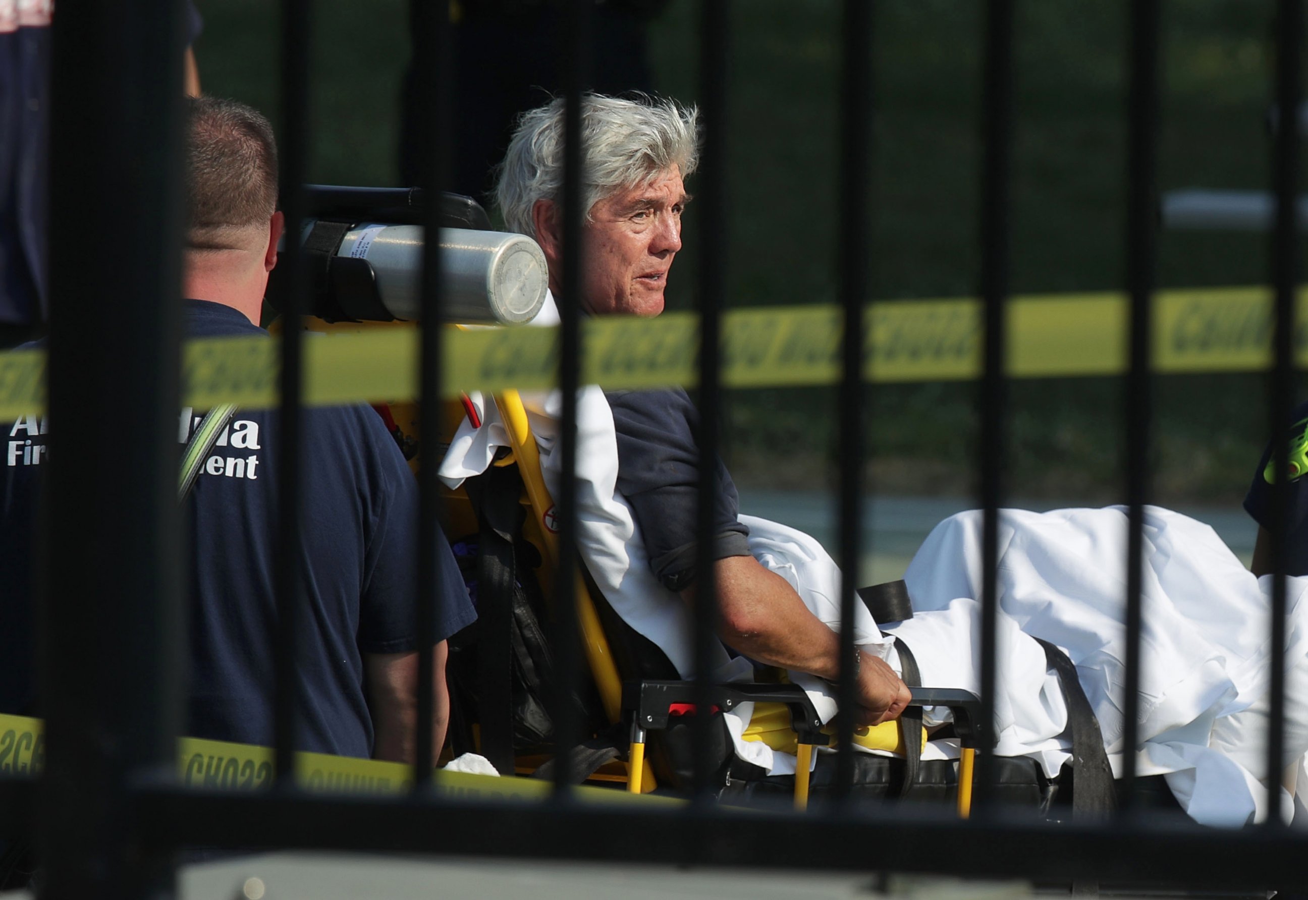 PHOTO: Rep. Roger Williams is wheeled away by emergency medical service personnel from the Eugene Simpson Stadium Park June 14, 2017 in Alexandria, Va., following a shooting at the park. 