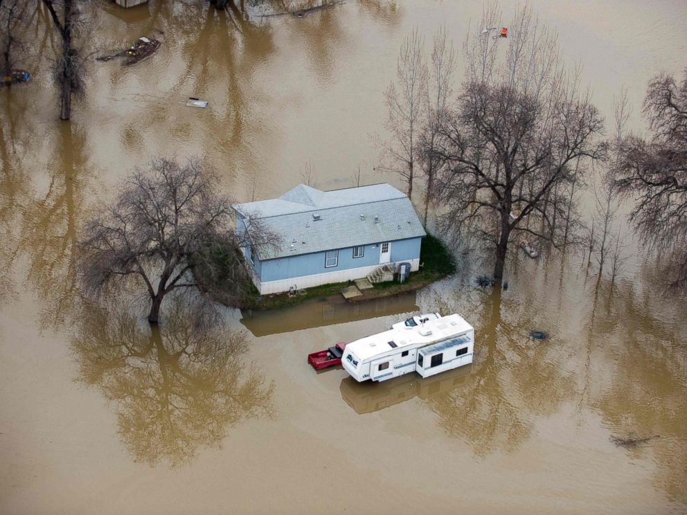 PHOTO: A home is seen marooned as the surrounding property is submerged in flood water in Oroville, California, Feb. 13, 2017.