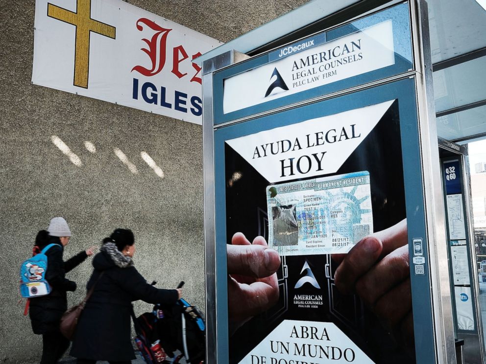 PHOTO: A sign at a bus stop advertises immigration services in a neighborhood of the Queens borough of New York City with a large Latino immigrant population on Feb. 14, 2017.