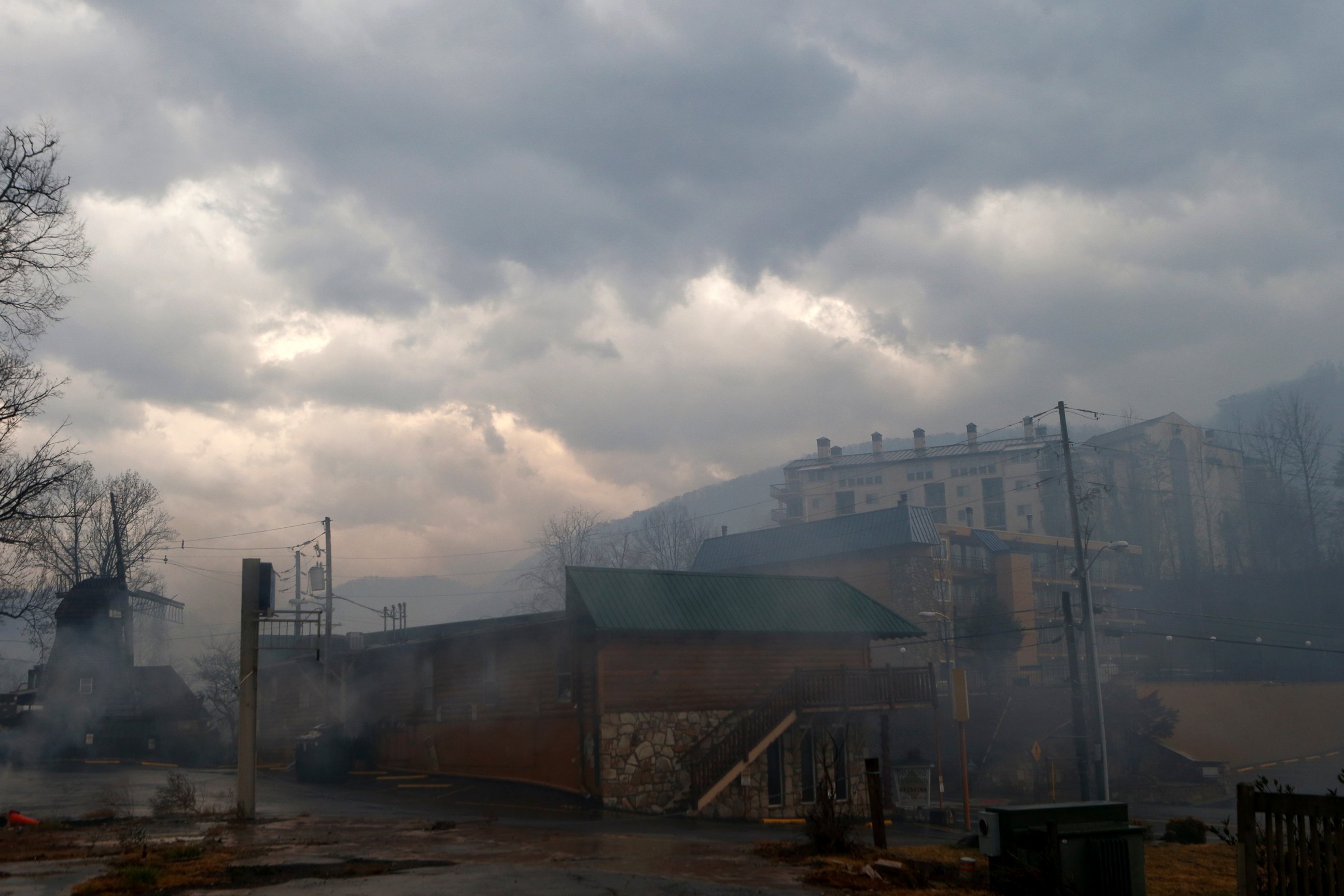 PHOTO: Smoke fills the air and surrounds businesses and resorts in the wake of a wildfire, Nov. 30, 2016, in downtown Gatlinburg, Tennessee. 