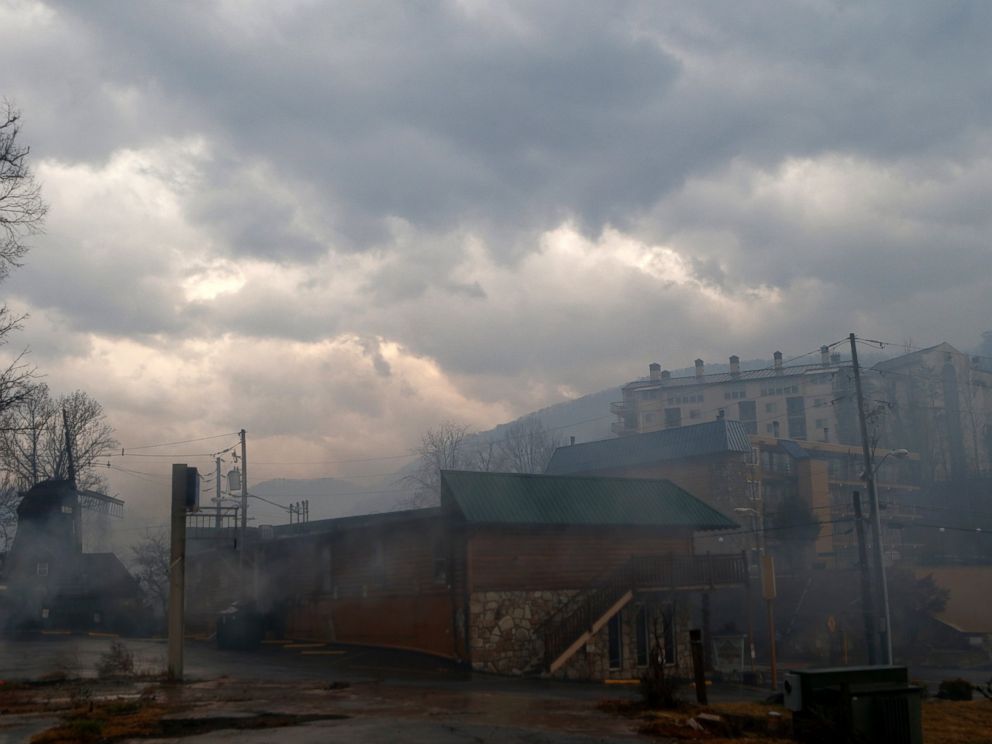 PHOTO: Smoke fills the air and surrounds businesses and resorts in the wake of a wildfire, Nov. 30, 2016, in downtown Gatlinburg, Tennessee.