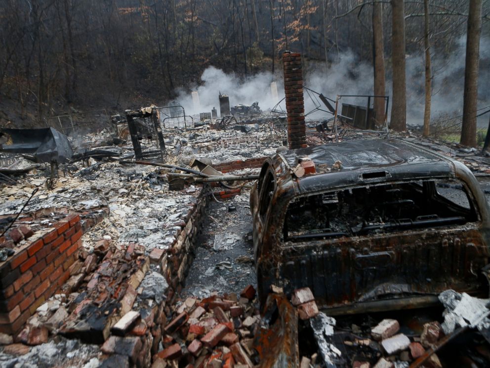 PHOTO: The remains of a home smolder in the wake of a wildfire, Nov. 30, 2016, in Gatlinburg, Tennessee.