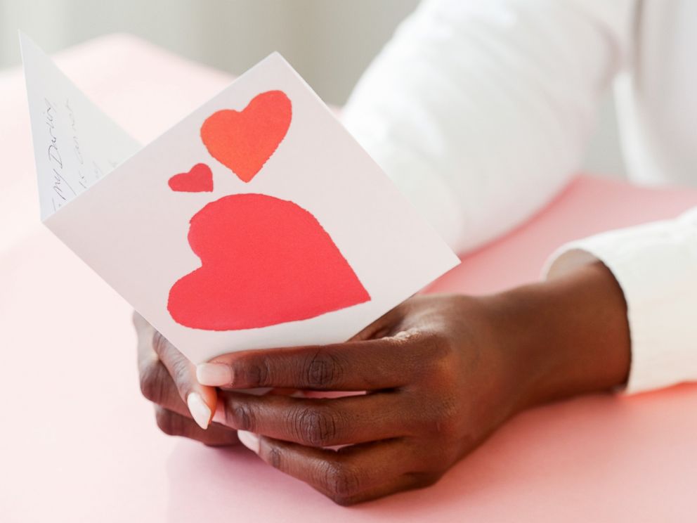 PHOTO: A woman holds a Valentine card in an undated stock photo.