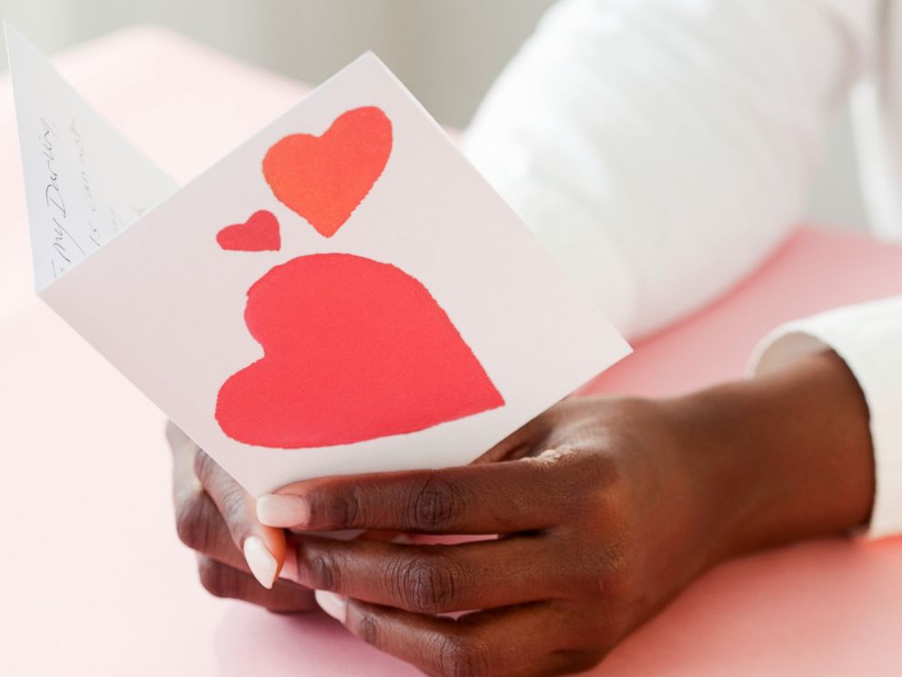 PHOTO: A woman holds a Valentine card in an undated stock photo.