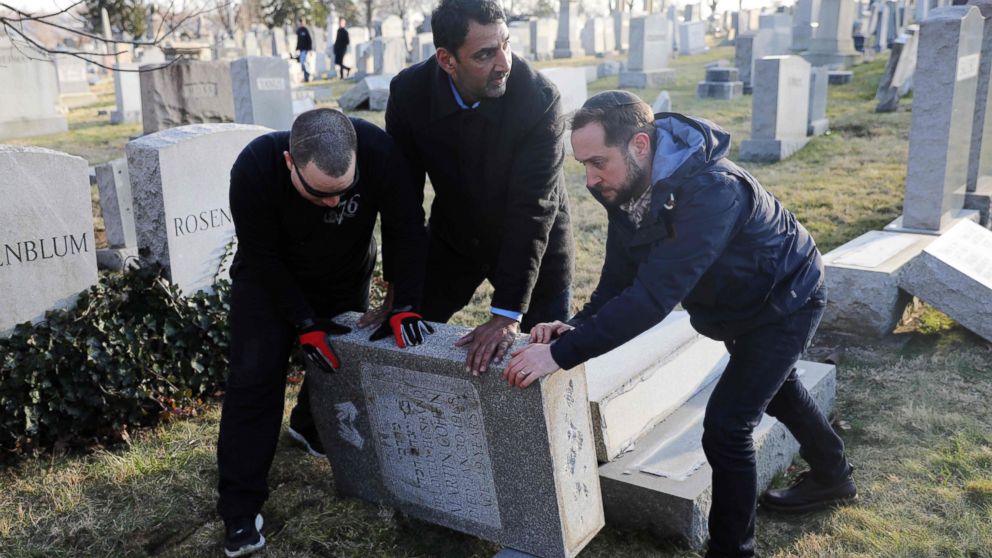 PHOTO: Three men help re-set a tombstone at the Jewish Mount Carmel Cemetery, Feb. 26, 2017, in Philadelphia. 