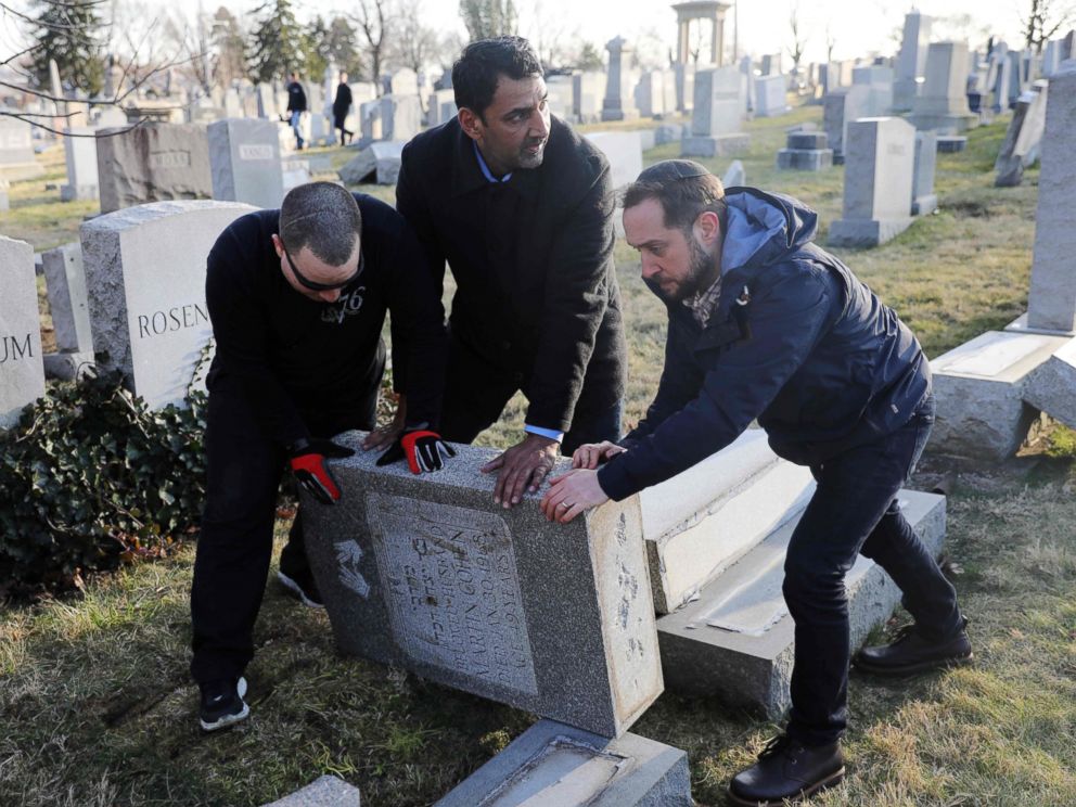 PHOTO: Three men help re-set a tombstone at the Jewish Mount Carmel Cemetery, Feb. 26, 2017, in Philadelphia.