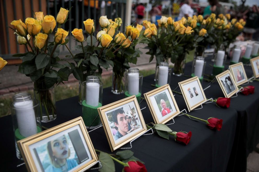 PHOTO: Pictures of victims of the Santa Fe High School shooting are displayed during a prayer vigil at Walter Hall Park, May 20, 2018, in League City, Texas.